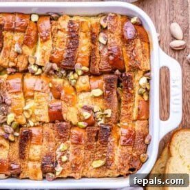 French toast casserole in a dish, topped with chopped pistachios.