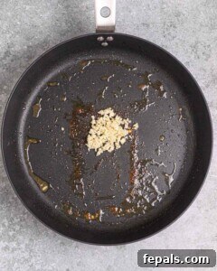 minced garlic in a pan to be seared.