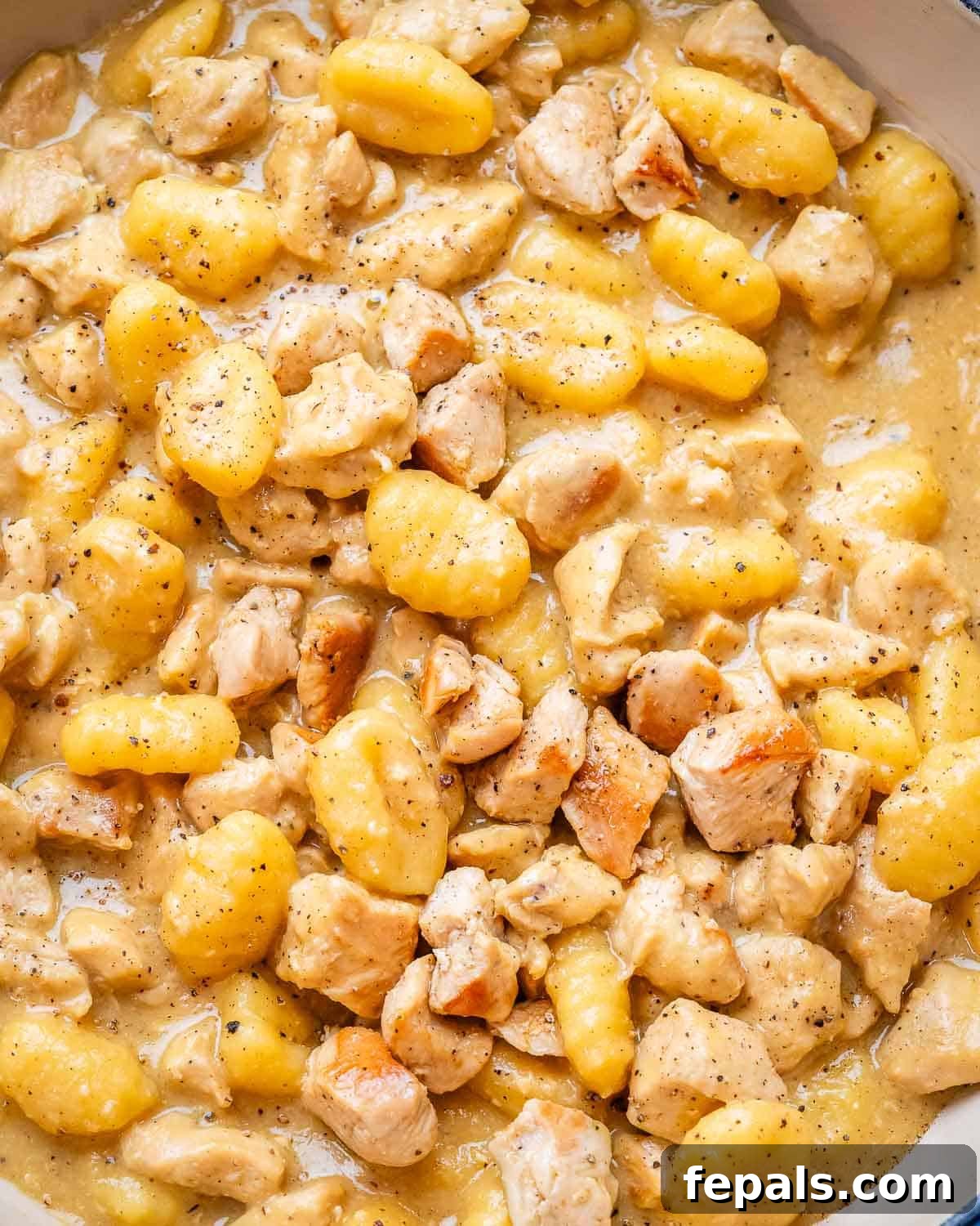 Pillowy Gnocchi Carbonara 2 A close up image of one pan gnocchi carbonara in a skillet, showcasing its creamy texture and juicy chicken.