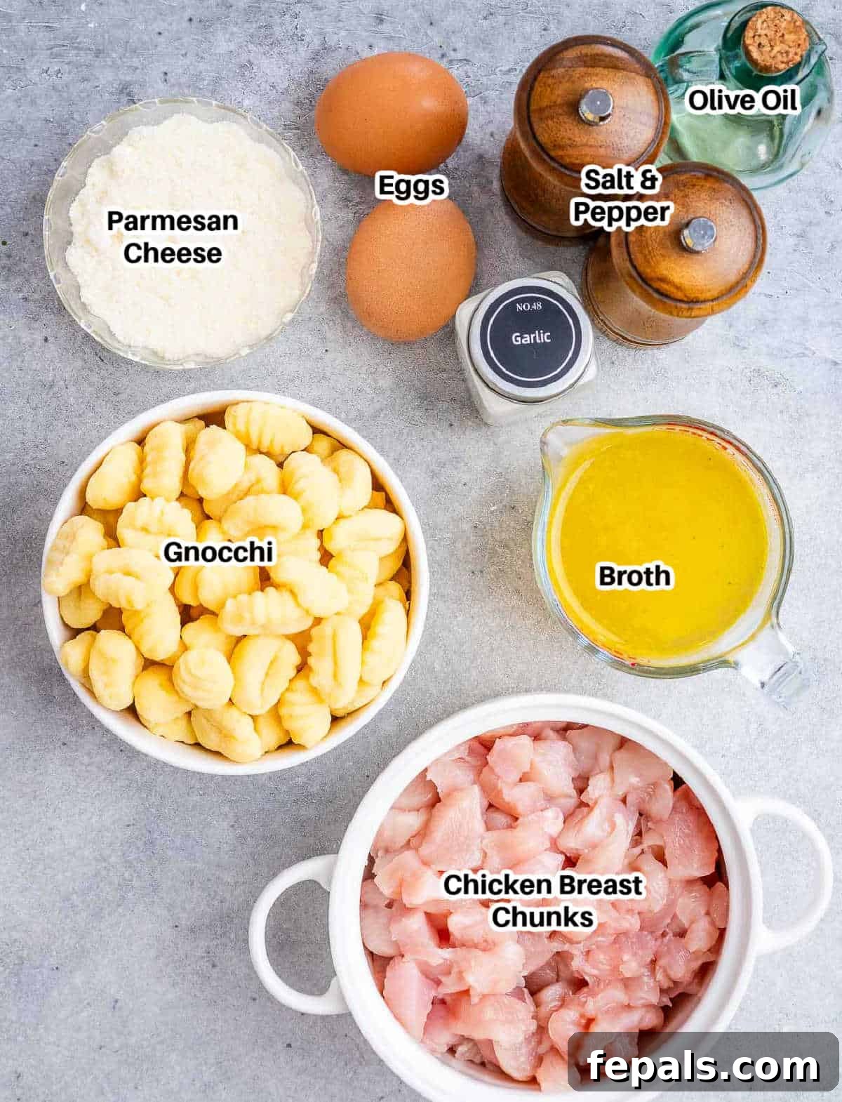 Pillowy Gnocchi Carbonara 3 Various fresh ingredients laid out, essential for making Gnocchi Carbonara, including chicken, gnocchi, eggs, and cheese.