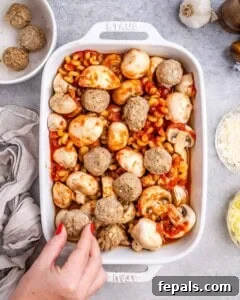 Placing meatballs into the dish.