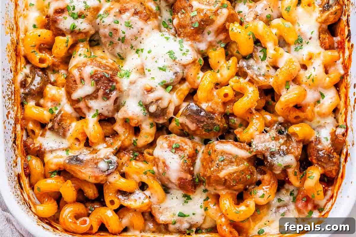 Effortless Meatball Bake 6 Baked pasta and meatballs in a white casserole dish, fresh from the oven.