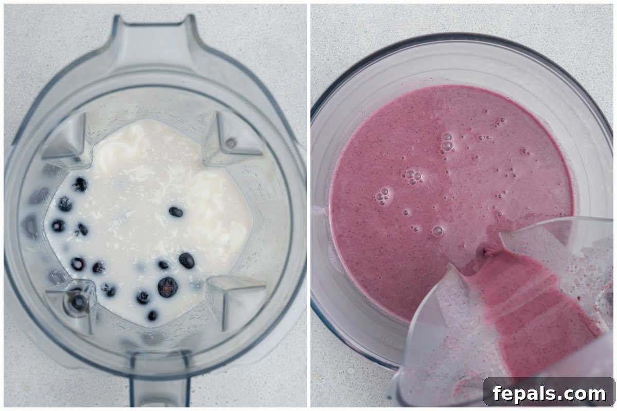 Easy Blueberry Overnight Oats 4 Process shot showing milk, yogurt, blueberries, and honey being blended in a high-speed blender to create a smooth, purple mixture for overnight oats.