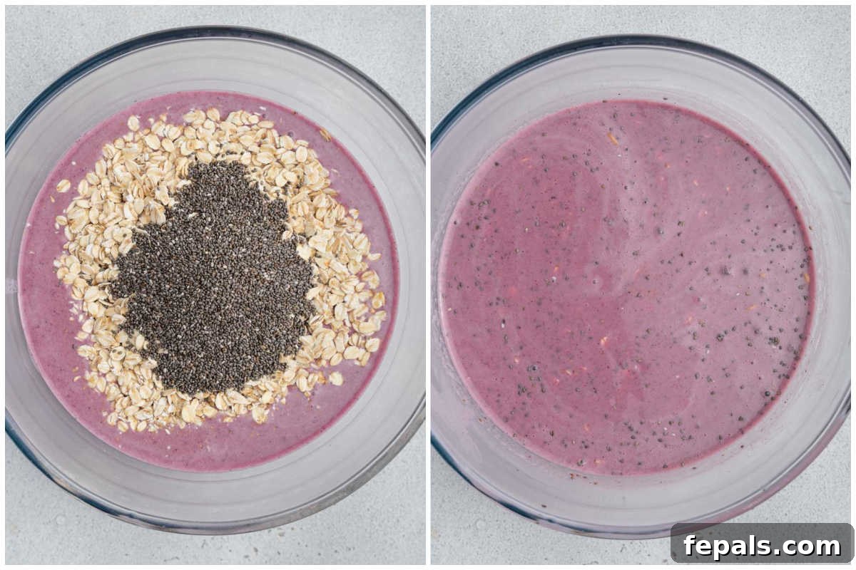 Easy Blueberry Overnight Oats 5 Process shot showing rolled oats and chia seeds being added to the blended blueberry milk in a mixing bowl, ready for stirring.