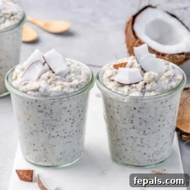 A side view image of two inviting jars of coconut cream pie overnight oats, generously topped with fresh coconut flakes for an irresistible tropical touch.