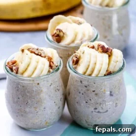 Three beautifully prepared jars of banana bread overnight oats, topped with perfectly sliced bananas and crunchy pecans, offering a comforting and wholesome breakfast.