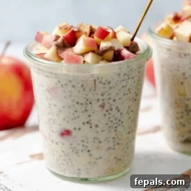 A side view of a jar of wholesome apple pie overnight oats, garnished with beautifully chopped apples on top, evoking the cozy warmth of a classic dessert.