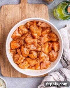 chicken chunks marinated in a bowl.