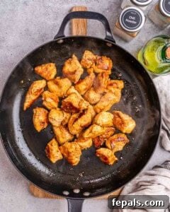 cooked chicken bites in a skillet.