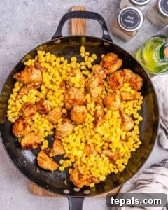 corn added over the seared chicken bites.