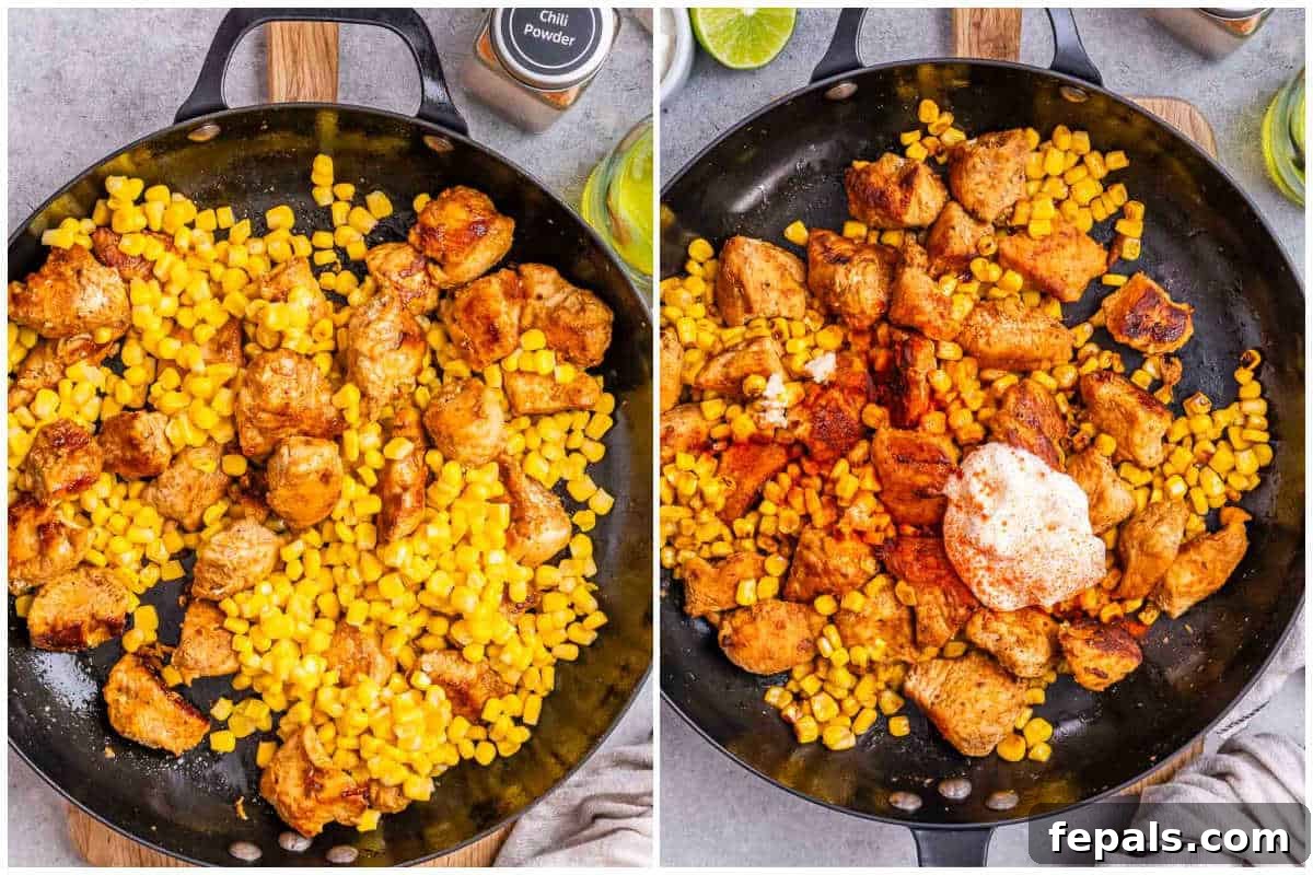 Seared chicken chunks and corn kernels being cooked together in a large skillet, with visible browning and slight charring on the corn.