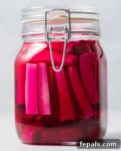 A sealed jar of pickling turnips sits on a counter, undergoing the initial room temperature fermentation process.