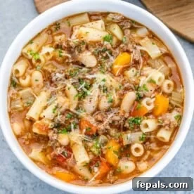 A comforting bowl of pasta fagioli soup with minced meat and veggies.