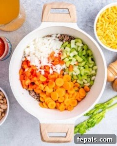 Sautéing vegetables with ground beef.