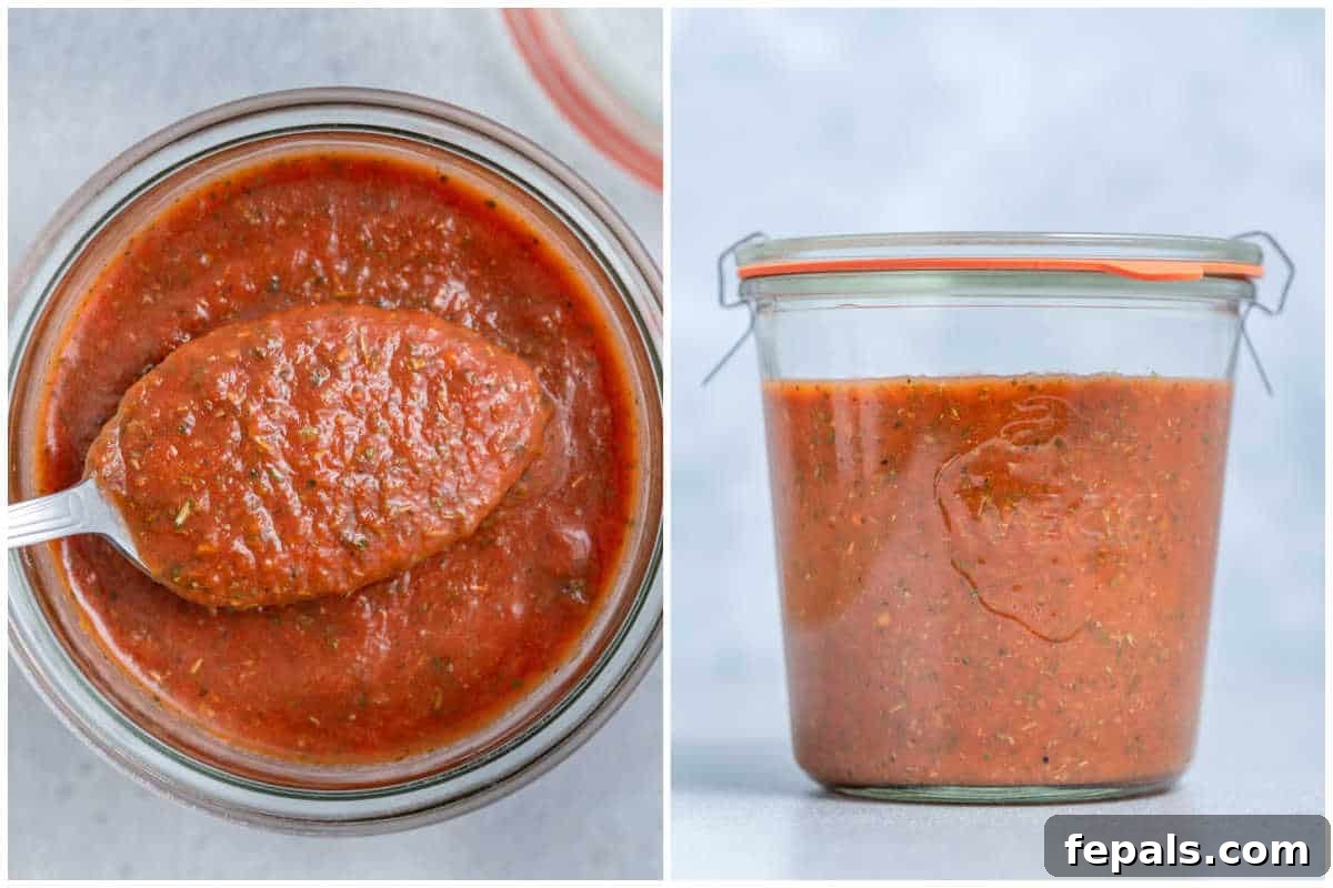 A process shot showing the freshly blended homemade pizza sauce being poured into a clean glass jar for storage, highlighting its readiness.
