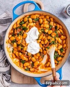 Yogurt added over the beans and sauce in the skillet.
