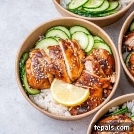 A perfectly portioned round bowl for chicken and rice meal prep, featuring tender sliced chicken, fresh cucumber, and fluffy white rice.