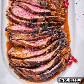 Valentine's Day Recipes for Grown-Ups 7 sliced marinated steak on a white plate set in a molasses steak sauce.