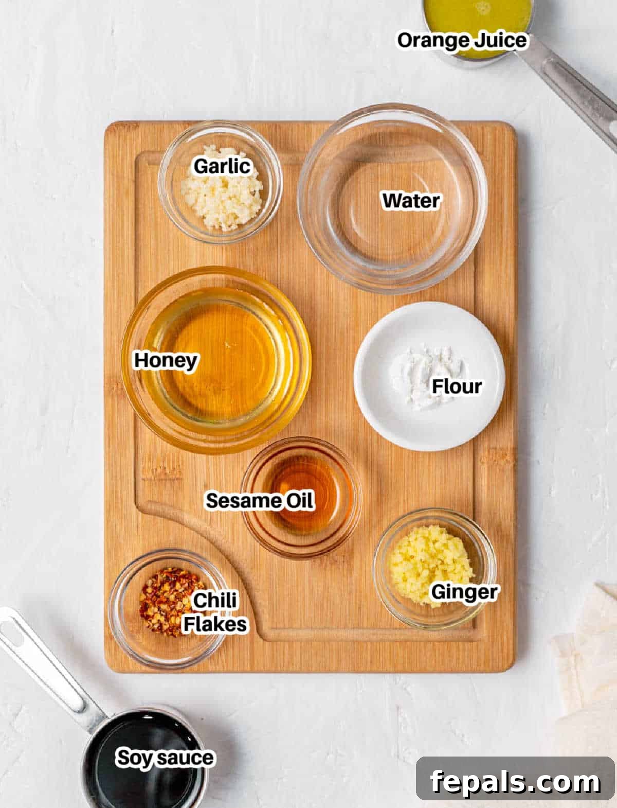 Your Own Signature Teriyaki Sauce 2 A vibrant display of fresh ingredients for teriyaki sauce, including soy sauce, honey, ginger, garlic, and an orange.