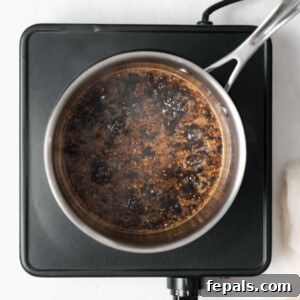 Your Own Signature Teriyaki Sauce 9 Teriyaki sauce simmering in a saucepan on the stove.