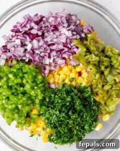 All salsa ingredients placed in a bowl before mixing.