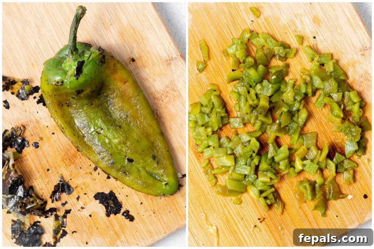A roasted poblano pepper on a cutting board, being peeled and then chopped for the salsa.