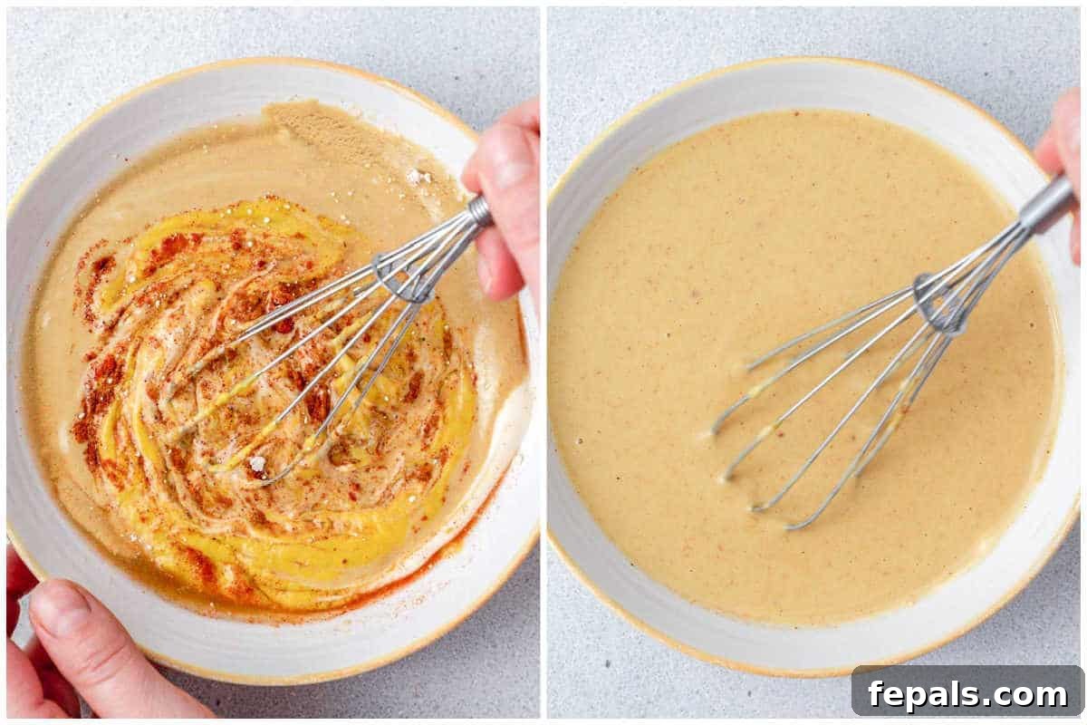 A hand mixing the sauce ingredients in a bowl with a whisk until smooth and combined.