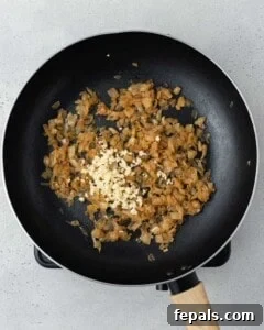 Decadent French Onion Dip 12 Process shot of adding the dip ingredients in bowl with the sauteed onions.