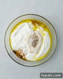 Decadent French Onion Dip 14 A bowl with french onion dip and grabbing a bite with chips.
