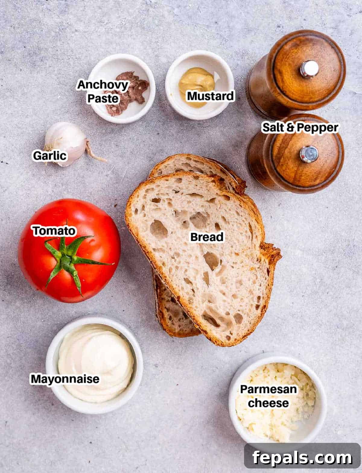 Ingredients laid out on a table to make a delicious tomato sandwich.