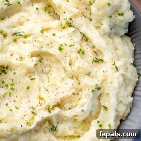 Top down shot of mashed potatoes in a grey bowl.