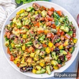A mixed veggie with lentil salad in a round bowl.