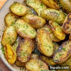 top view of roasted potatoes in an orange skillet