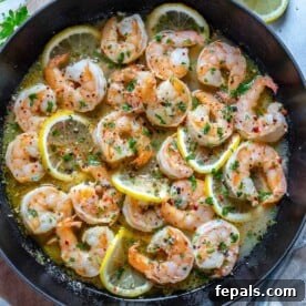 top view of sauteed shrimp in a black skillet