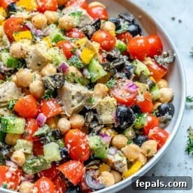 A generously sized bowl filled with vibrant Mediterranean Chickpea Salad, showcasing its fresh ingredients.