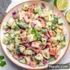 A tempting top-down view of a fresh shrimp and avocado salad in a large bowl.