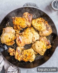 Searing chicken thighs in a skillet