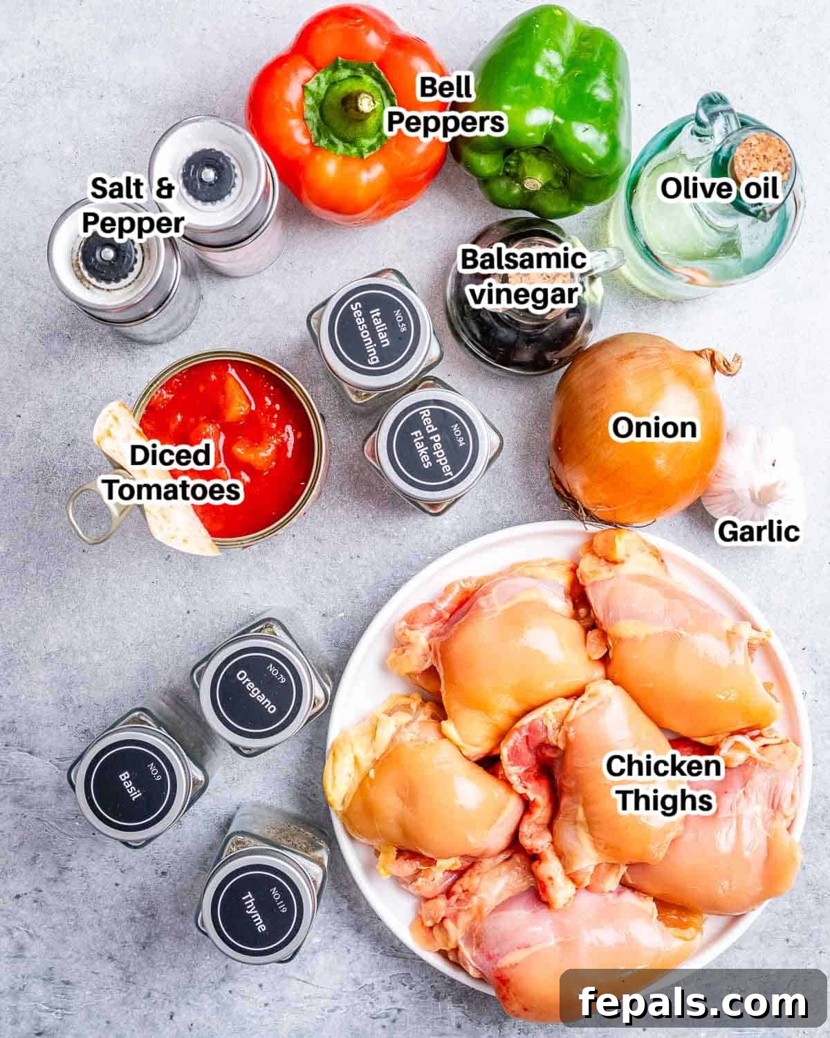 Rustic Hunter's Chicken 3 A vibrant selection of fresh ingredients laid out for Chicken Cacciatore, including chicken thighs, colorful bell peppers, onions, garlic, and canned tomatoes.