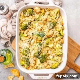 a dish with chicken divan with broccoli topped with melted cheese.
