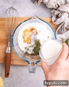 Mixing the Greek yogurt sauce in a bowl.