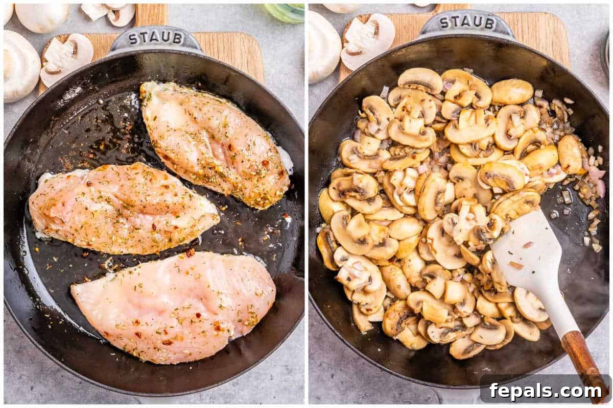 Two pieces of seared chicken breast in a skillet, one golden brown side up, ready to be stuffed.