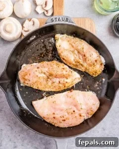 cooked chicken breasts in a skillet.