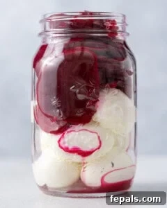 Ruby Red Pickled Eggs 11 Glass mason jar packed tightly with pickled eggs and beets before all the liquid is added in.