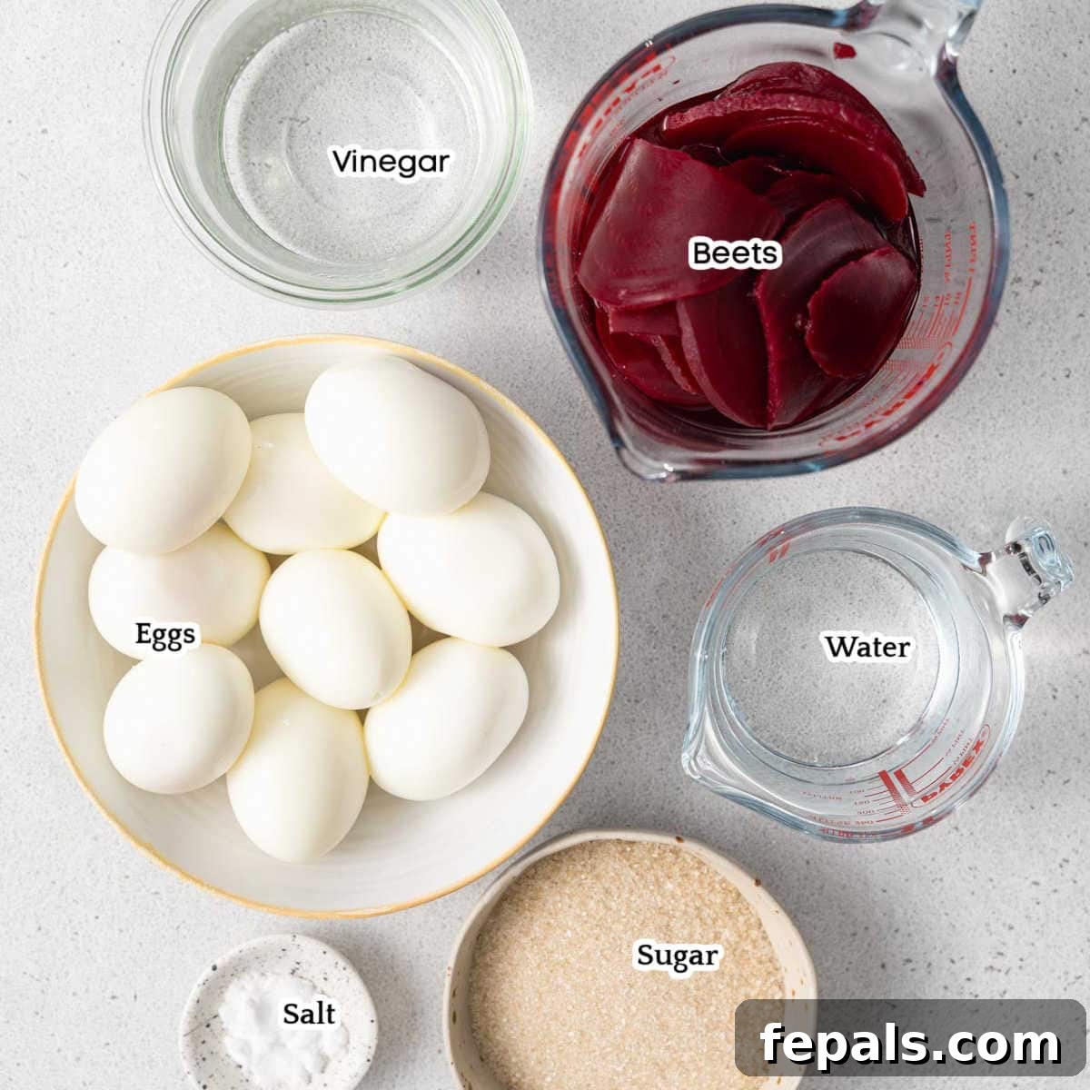 Ruby Red Pickled Eggs 4 A flat lay of ingredients for beet-pickled eggs, including hard-boiled eggs, canned beets, white vinegar, cane sugar, kosher salt, and water.
