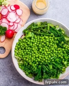 Making a salad with peas, broccoli, asparagus and radishes.