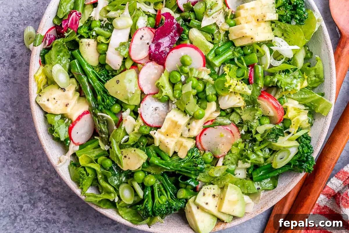 A beautifully presented bowl filled with a vibrant spring mix salad, ready to be served.