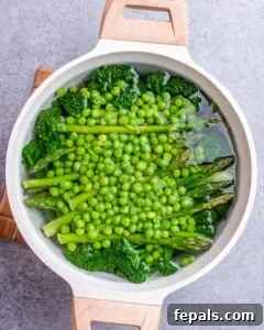 Blanching peas, asparagus and broccoli in a large pot.