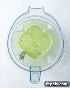 Shamrock smoothie being blended in a high-speed blender.