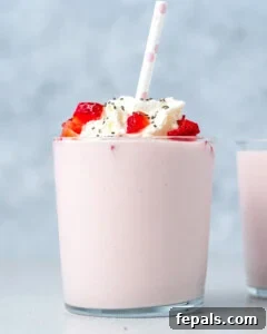 serving a strawberry smoothie in a cup.