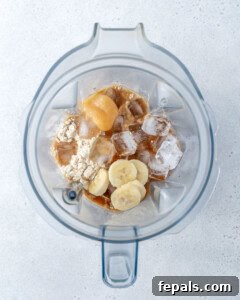 adding all the shake ingredients into blender to make coffee protein shake.